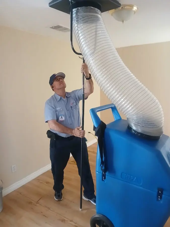 Furnace Tune-Up technician using HEPA equipment in Ladue